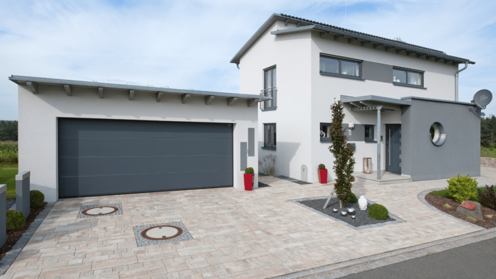 Modernes Einfamilienhaus mit Kunststoff-Fenstern in verschiedenen Formen.
